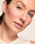Model wearing Glowify Long-Lasting Eyeshadow Stick product shade Rose Gold.