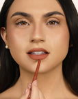 Model applying LipSense Long-Lasting Lip Liner Pencil product shade Rustic Maple.