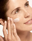 Model applying Microbiome Defense Daytime Moisturizer SPF 15.