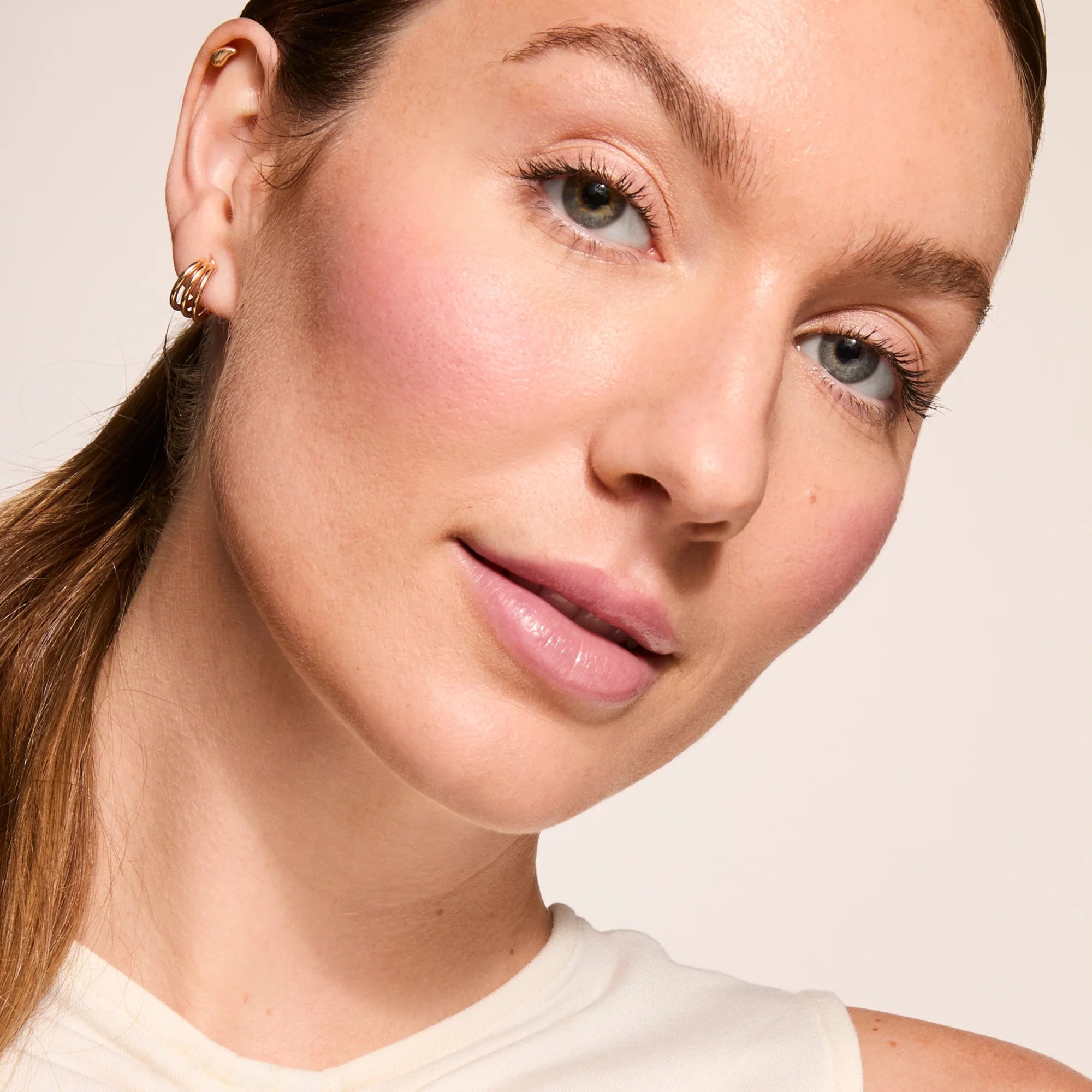 Model wearing Glowify Long-Lasting Eyeshadow Stick product shade Rose Gold.