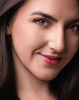 Model wearing Glowify Sheer Silk Lip Oil product shade Rose Water.