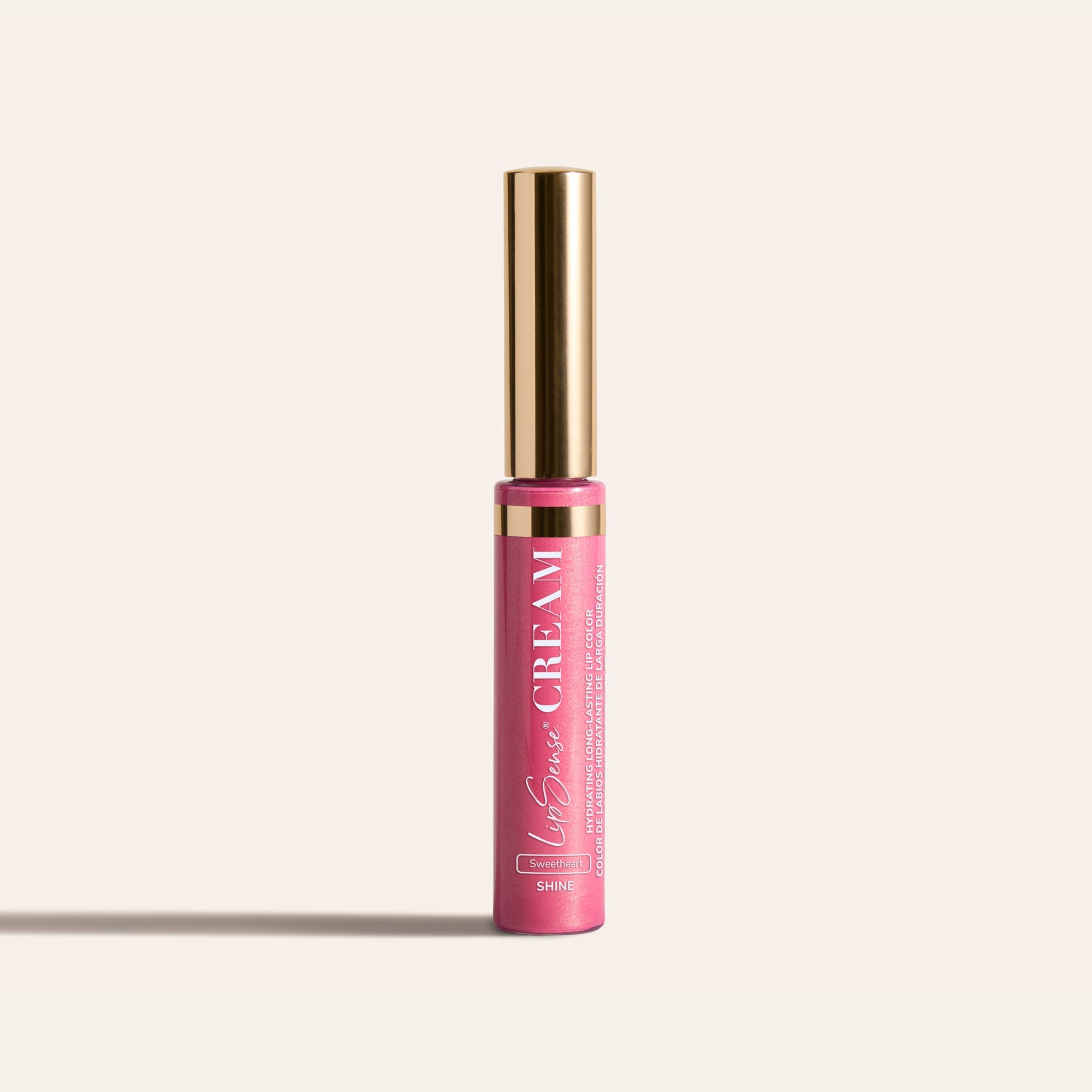 LipSense HydraMatte pink lip color bottle with a tall gold cap on a light beige background