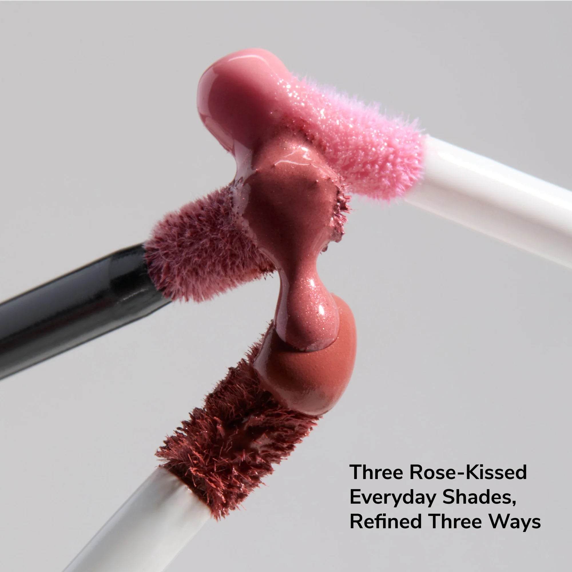 Three LipSense wands with pink mauve gloss from the Ethereal collection meeting in a glossy droplet