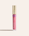 Pink sheer silk lip oil in a clear tube with a gold decorative cap standing upright