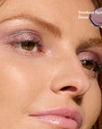 Close-up of a model's eye with pink shimmering eyeshadow from Ethereal ShadowSense Eyeshadow Duo CN and a Smoked Spice + Dove swatch in the corner
