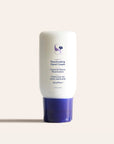 White Reactivating Hand Cream bottle with purple cap on a pale background