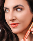 Model wearing LipSense Lip Color shade Coral Reef product
