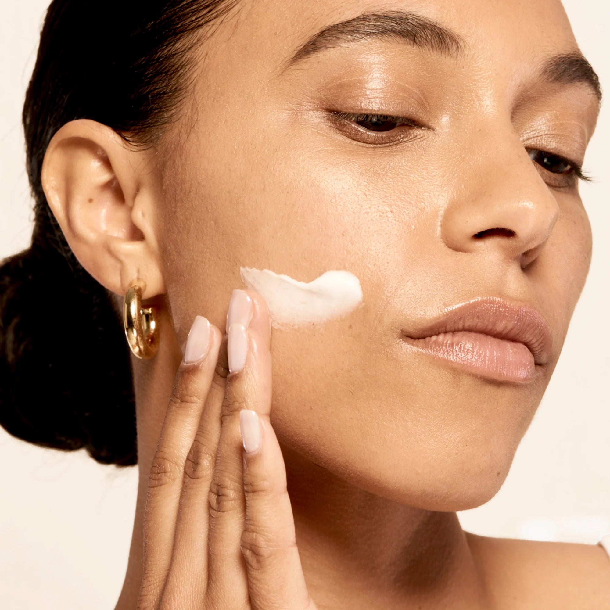 Model applying Microbiome Restorative Evening Moisturizer.