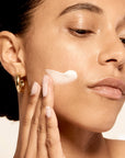 Model applying Microbiome Restorative Evening Moisturizer.