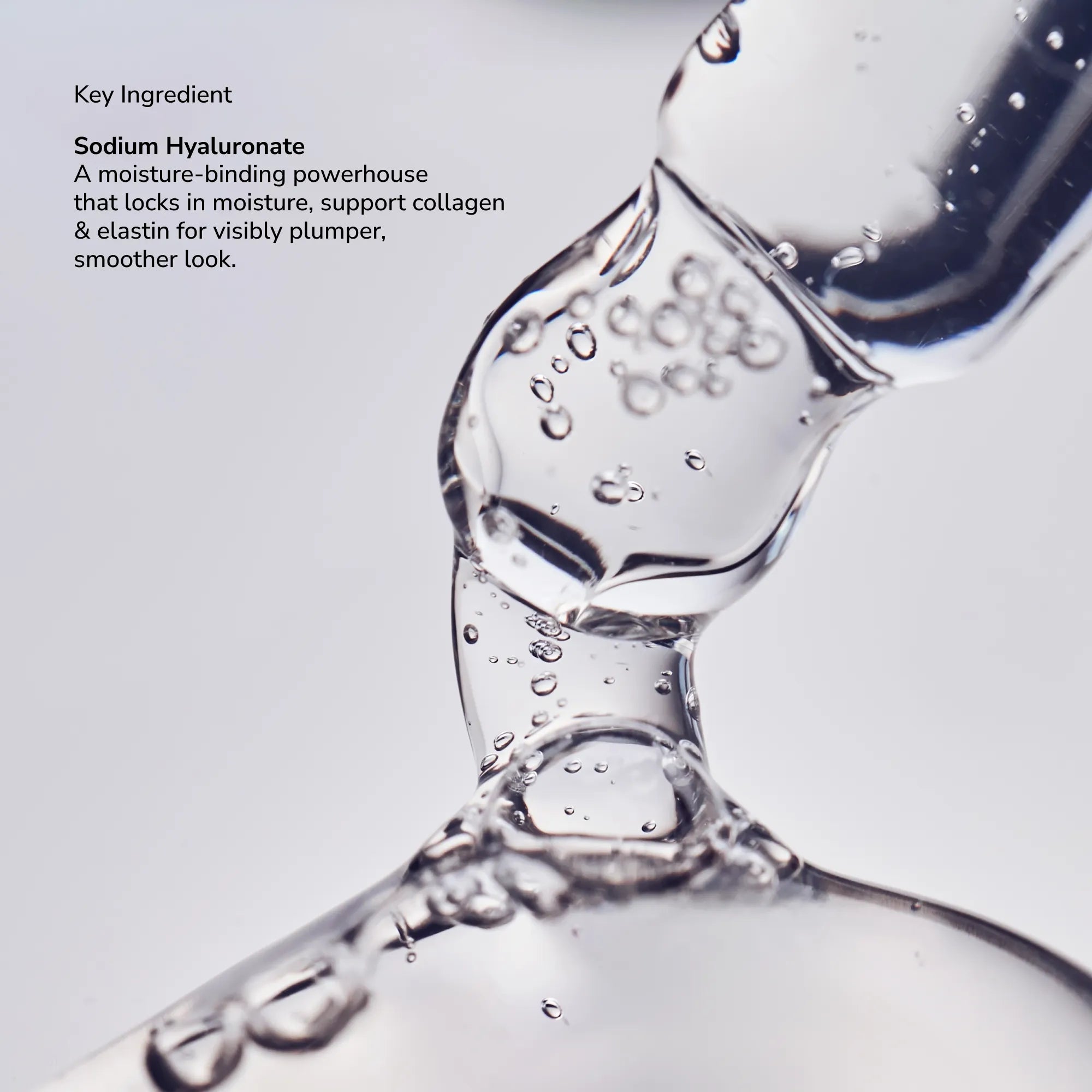 Close-up of a clear viscous liquid being poured with bubbles, highlighting Sodium Hyaluronate as a key ingredient.