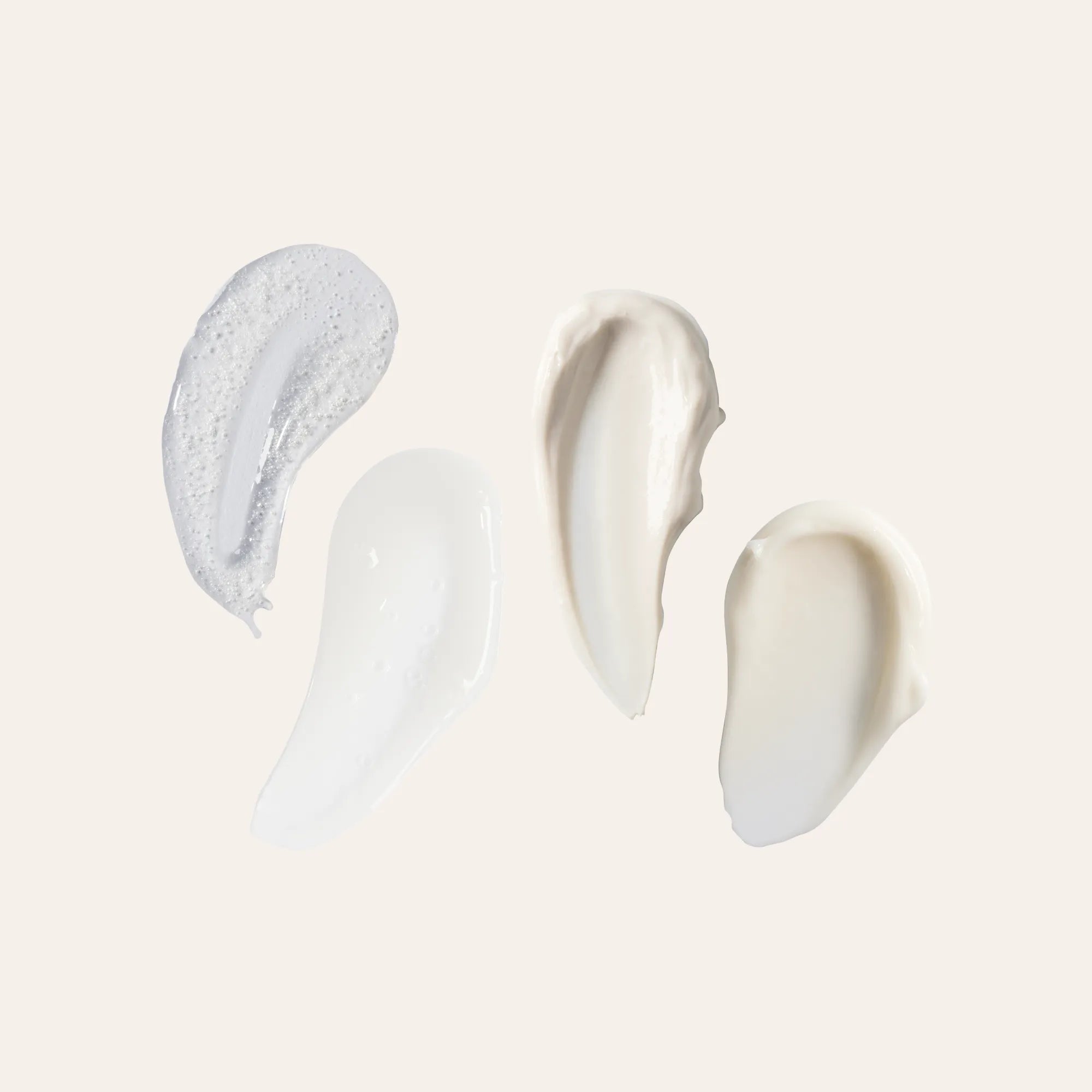 Four cream swatches from the Microbiome Skincare Regimen Set NZL on a neutral background
