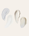 Four cream swatches from the Microbiome Skincare Regimen Set NZL on a neutral background