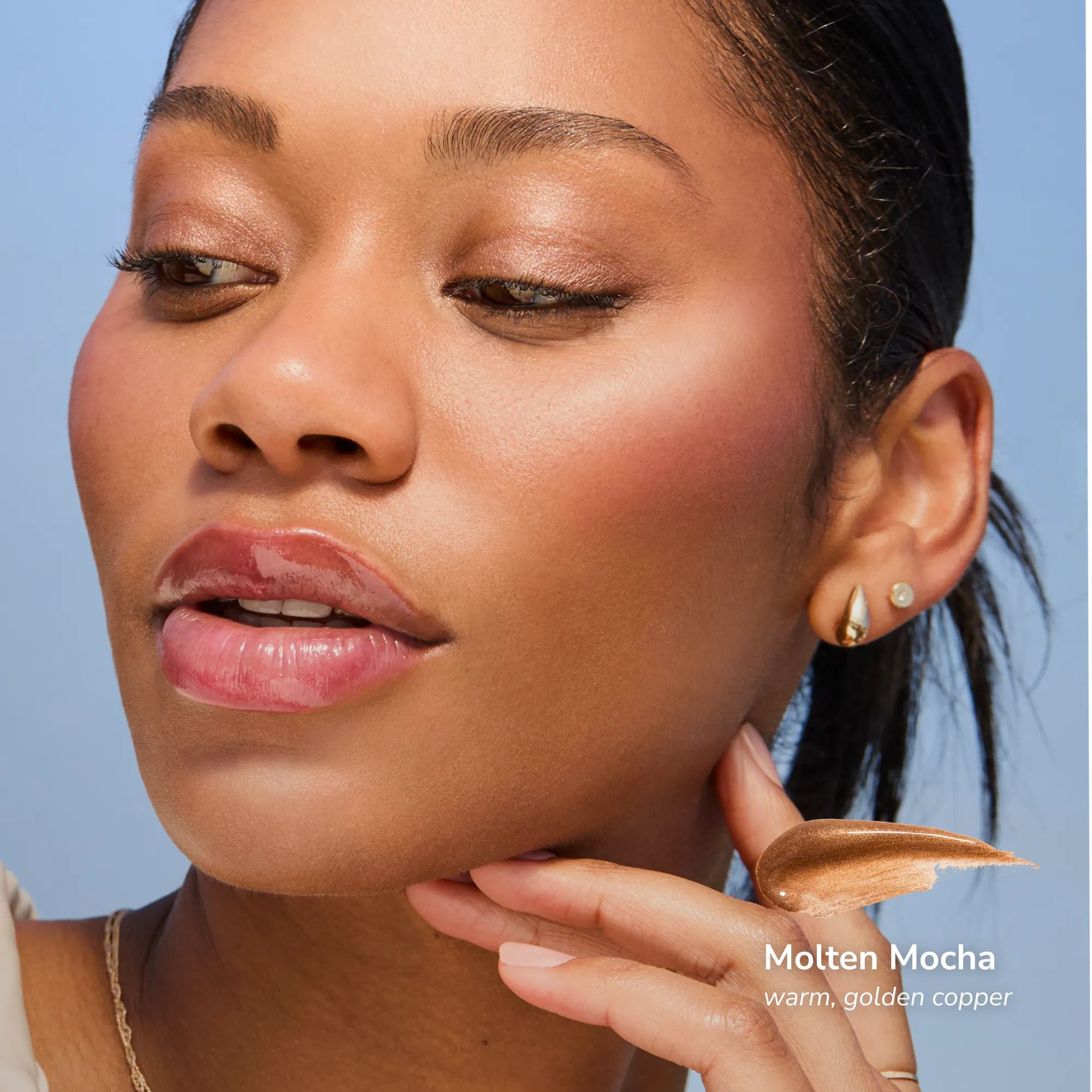 Model wearing Pearlizer Highlighter product shade Molten Mocha