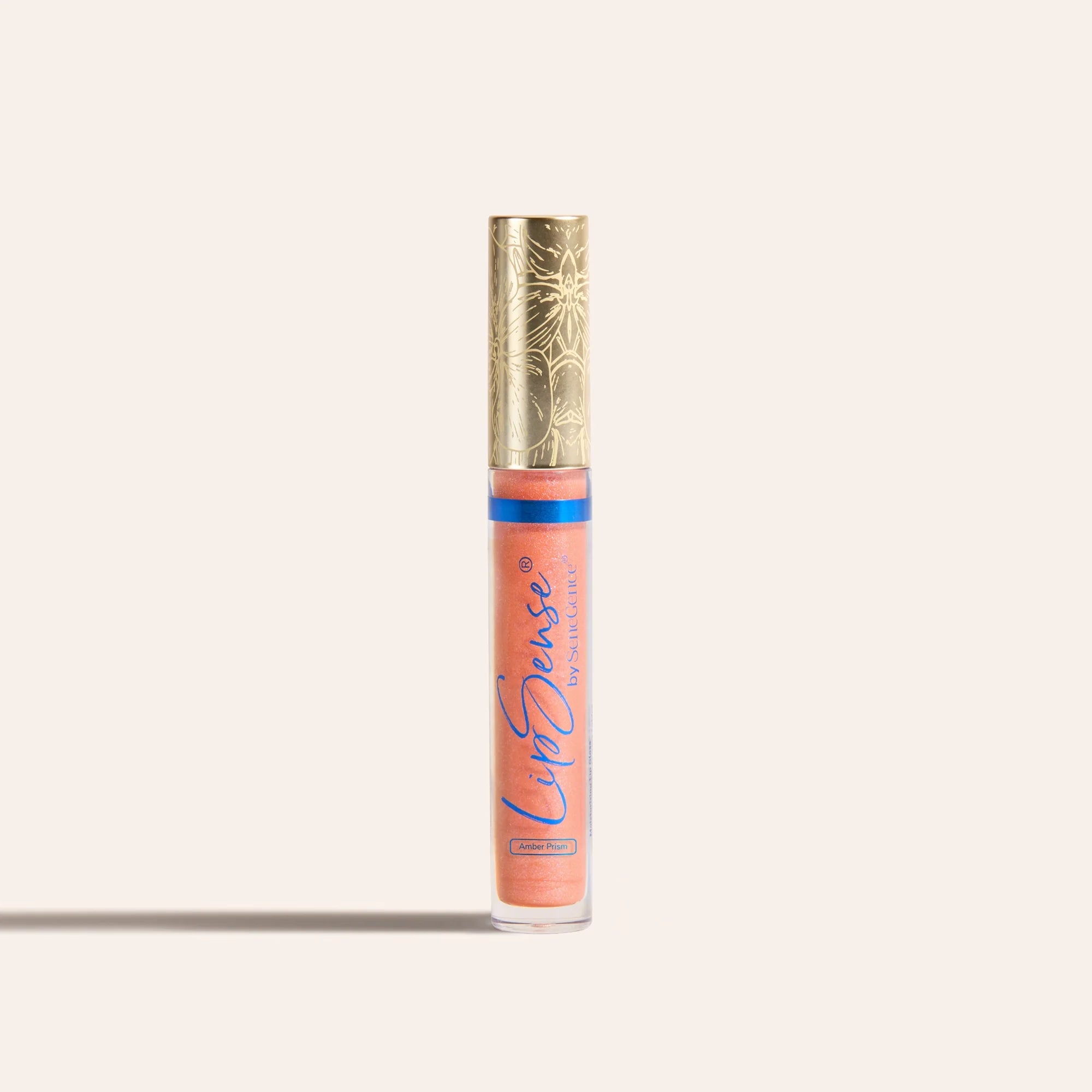 LipSense moisturizing gloss in a peach shade in a clear tube with a gold ornate cap.