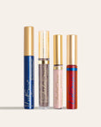 Four gold capped cosmetic tubes from The Soft Dusk Look NZ arranged in a row on a pale background.