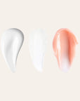 Three lip care swatches on a beige background white cream white balm and peach tinted cream